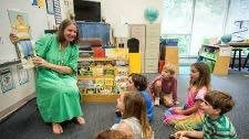 teacher reading to a group of students