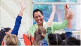 instructor raising hands with students