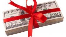 a stack of bills with a red bow tied around it